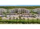 Exterior view of a multi-story residential building with covered parking and manicured landscaping at 17626 Gawthrop Dr # 305, Bradenton, FL 34211