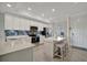 Bright kitchen featuring modern appliances, white cabinets, and a large island at 17626 Gawthrop Dr # 305, Bradenton, FL 34211