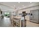 Bright kitchen featuring modern appliances, white cabinets, and a large island at 17626 Gawthrop Dr # 305, Bradenton, FL 34211