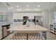 Bright kitchen with stainless steel appliances, quartz countertops, and mosaic tile backsplash at 17626 Gawthrop Dr # 305, Bradenton, FL 34211