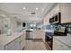 Bright kitchen featuring modern appliances, white cabinets, and a large island at 17626 Gawthrop Dr # 305, Bradenton, FL 34211