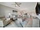 An open-concept living space featuring comfortable seating, a ceiling fan, and ample natural light at 17626 Gawthrop Dr # 305, Bradenton, FL 34211