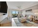 Bright living room with comfortable seating, ceiling fan, and large windows overlooking a balcony at 17626 Gawthrop Dr # 305, Bradenton, FL 34211
