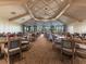 Large meeting room features tables and chairs with large windows for natural light and views of the surrounding area at 17626 Gawthrop Dr # 305, Bradenton, FL 34211