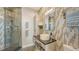 Modern bathroom with glass-enclosed shower, decorative tile, and stylish vanity at 1771 Ringling Blvd # 1212, Sarasota, FL 34236