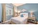 Comfortable bedroom with hardwood floors, shuttered windows, and dual nightstands at 1771 Ringling Blvd # 1212, Sarasota, FL 34236