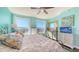Bright bedroom featuring turquoise walls, dark hardwood floors, and large sunny windows offering city views at 1771 Ringling Blvd # 1212, Sarasota, FL 34236
