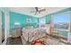 Bright bedroom featuring turquoise walls, dark hardwood floors, and a floral area rug, with ample natural light at 1771 Ringling Blvd # 1212, Sarasota, FL 34236