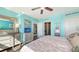 Bright bedroom featuring turquoise walls, dark hardwood floors, and a mirrored dresser at 1771 Ringling Blvd # 1212, Sarasota, FL 34236
