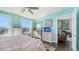 Bright bedroom featuring turquoise walls, dark hardwood floors, and an open living area at 1771 Ringling Blvd # 1212, Sarasota, FL 34236