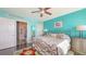 Bright bedroom featuring turquoise walls, dark hardwood floors, and an ensuite bathroom at 1771 Ringling Blvd # 1212, Sarasota, FL 34236