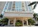 Grand entrance to the building featuring well-maintained landscaping at 1771 Ringling Blvd # 1212, Sarasota, FL 34236