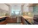 Contemporary kitchen featuring custom cabinetry and top-of-the-line appliances at 1771 Ringling Blvd # 1212, Sarasota, FL 34236