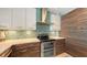 Modern kitchen featuring sleek, two-tone cabinetry, stainless steel appliances, and a vibrant backsplash at 1771 Ringling Blvd # 1212, Sarasota, FL 34236