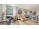 Stylish living room with vibrant artwork, comfortable seating, and an open layout into the dining area at 1771 Ringling Blvd # 1212, Sarasota, FL 34236