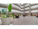 Spacious lobby area with lush greenery and comfortable seating at 1771 Ringling Blvd # 1212, Sarasota, FL 34236