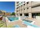 Inviting pool and spa area features lounge chairs, palm trees, and high-rise views at 1771 Ringling Blvd # 1212, Sarasota, FL 34236