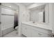 Bright bathroom featuring a tub with shower and vanity with quartz countertops at 17966 Grand Prosperity Dr, Venice, FL 34293