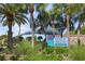 Venice Beach entrance sign with palm trees and lush greenery at 17966 Grand Prosperity Dr, Venice, FL 34293