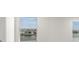 Bright bedroom with white walls and two windows offering views of the lake at 17966 Grand Prosperity Dr, Venice, FL 34293