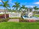View of the Sunstone Wellen Park entrance sign showcasing lush landscaping, a water feature, and a welcoming aesthetic at 17966 Grand Prosperity Dr, Venice, FL 34293