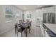 Dining room with a table set for four and a view of the lush landscape outside at 17966 Grand Prosperity Dr, Venice, FL 34293