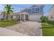 Beautiful two-story home with a paver driveway, covered porch, and well-manicured landscaping at 17966 Grand Prosperity Dr, Venice, FL 34293