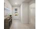 Bright foyer with neutral tile flooring, decorative accents, and a view to the outside at 17966 Grand Prosperity Dr, Venice, FL 34293