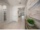 Bright foyer with neutral tile flooring, decorative accents, and a view into the living area and outdoor patio at 17966 Grand Prosperity Dr, Venice, FL 34293