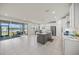 Open-concept kitchen with stainless appliances and island seating flowing into a dining area and screened patio at 17966 Grand Prosperity Dr, Venice, FL 34293