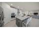 Modern kitchen with a center island with bar seating, stainless appliances and tiled backsplash at 17966 Grand Prosperity Dr, Venice, FL 34293