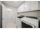 Bright laundry room featuring Samsung washer and dryer, white cabinetry and shelving, and a convenient storage room at 17966 Grand Prosperity Dr, Venice, FL 34293