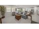 Bright open-concept living room with lake views, neutral decor, and tiled floors at 17966 Grand Prosperity Dr, Venice, FL 34293