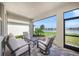 Covered patio featuring comfortable seating with a view of the serene lake and lush landscaping at 17966 Grand Prosperity Dr, Venice, FL 34293