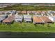 Rear exterior of this two-story home showing a spacious backyard, and screened in patio, and an idyllic view at 17966 Grand Prosperity Dr, Venice, FL 34293