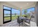 Outdoor screened patio with lake view and seating, perfect for relaxing and entertaining guests at 17966 Grand Prosperity Dr, Venice, FL 34293