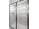 Modern walk-in shower featuring marble-look tiling and a window at 17966 Grand Prosperity Dr, Venice, FL 34293