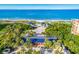 Stunning aerial view showcases beach access with cabanas and lush landscaping at 1912 Harbourside Dr # 602, Longboat Key, FL 34228
