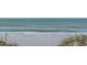 A scenic beach view of waves gently crashing onto the sandy shore, perfect for relaxation and coastal living at 1912 Harbourside Dr # 602, Longboat Key, FL 34228