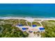 Aerial shot of beachfront cabanas for shade on sunny days by the ocean at 1912 Harbourside Dr # 602, Longboat Key, FL 34228