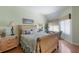 Comfortable bedroom with wood floors, a bed, and two side tables with lamps at 1912 Harbourside Dr # 602, Longboat Key, FL 34228