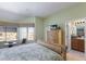 Bedroom with a TV, a chair, a bed, blinds, and a view to the bathroom at 1912 Harbourside Dr # 602, Longboat Key, FL 34228