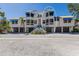 Beautiful condo building with blue awnings and well-maintained landscaping in a coastal setting at 1912 Harbourside Dr # 602, Longboat Key, FL 34228