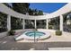 Relaxing hot tub surrounded by white columns, lush foliage, and a decorative fence at 1912 Harbourside Dr # 602, Longboat Key, FL 34228