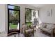 Enclosed sun room features tile floor, with views of the property's landscaping at 1912 Harbourside Dr # 602, Longboat Key, FL 34228