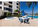 Relaxing pool area with a hot tub, an umbrella table, and views of the lush landscaping at 1912 Harbourside Dr # 602, Longboat Key, FL 34228