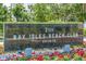 Elegant Bay Isles Beach Club sign surrounded by flowers creates a welcoming entrance at 1912 Harbourside Dr # 602, Longboat Key, FL 34228