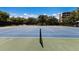 Well-maintained tennis courts surrounded by mature trees providing a private playing experience at 1912 Harbourside Dr # 602, Longboat Key, FL 34228