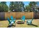 Inviting backyard fire pit surrounded by blue Adirondack chairs, perfect for outdoor gatherings and cozy evenings at 2001 25Th W Ave, Bradenton, FL 34205