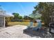 Spacious backyard with patio, lounge chairs, and lush greenery, perfect for outdoor relaxation and entertaining at 2001 25Th W Ave, Bradenton, FL 34205